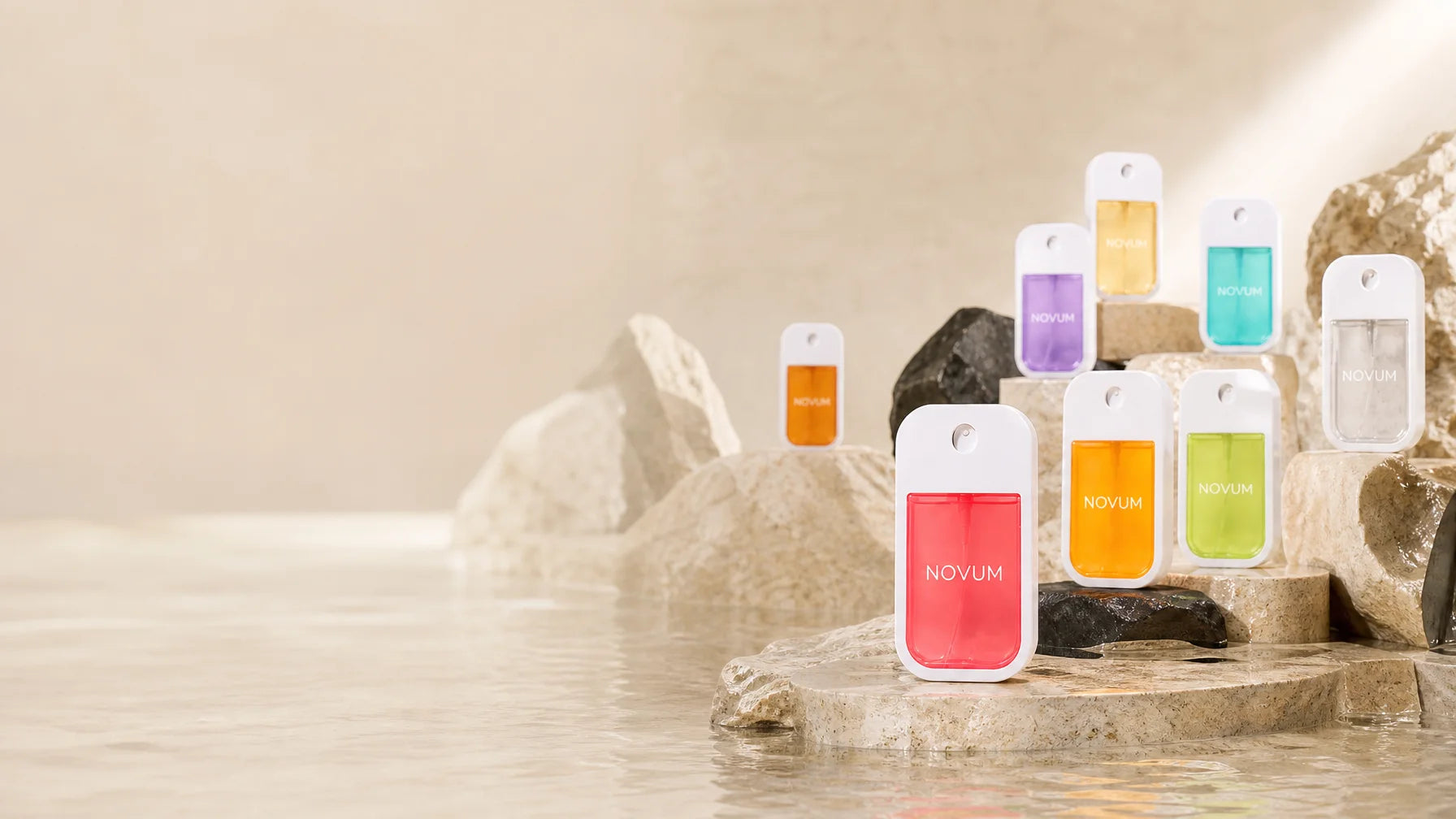 Premium e-commerce hero, 16:9. Stage the exact sourced NOVUM fragrance collection as a restrained pr